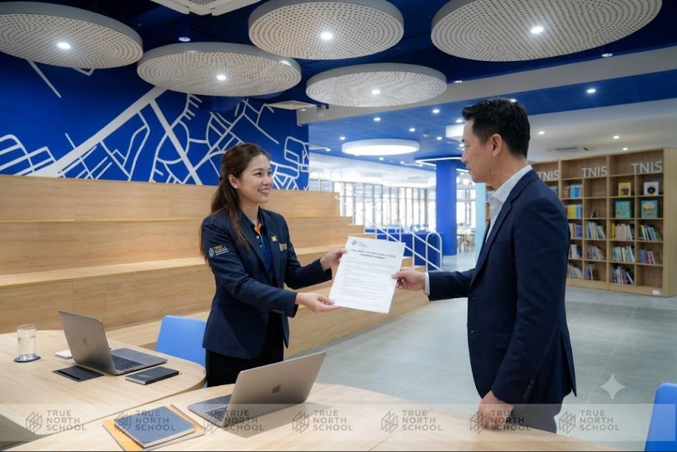 Parent receiving a written provisional placement after a transcript review at True North International School